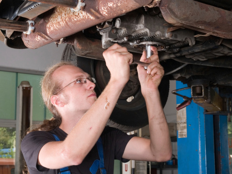 Mechanic Working on Car