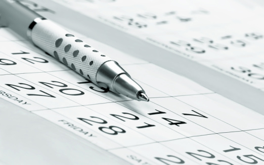 A pen on top of a calendar