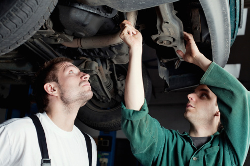 Mechanics Working on a Car