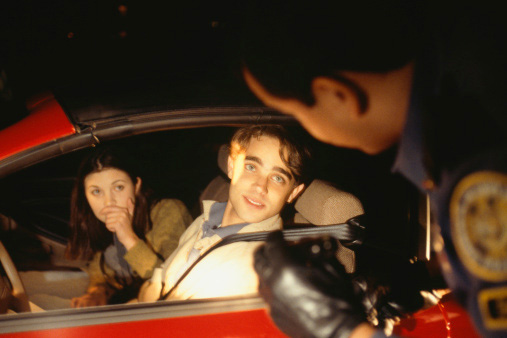 A police officer pulling over a teen
