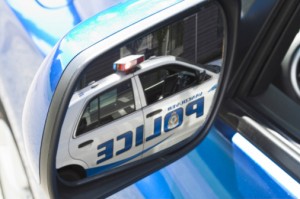 Police Car in Side Mirror of Car