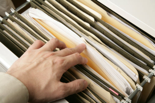 Hand Filing Paperwork