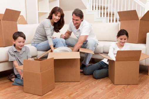 Family Unpacking Boxes in New Home