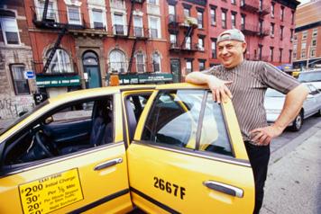 Taxi Driver Standing Next to Taxi