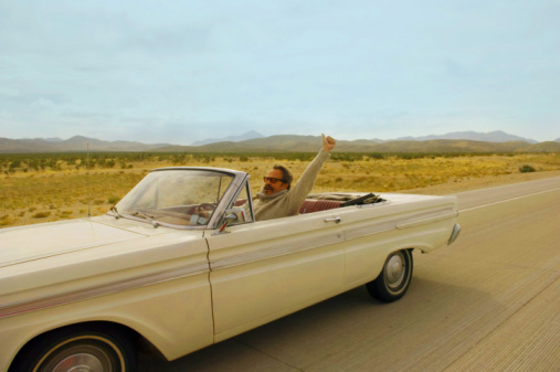 Excited Man Driving Down the Road