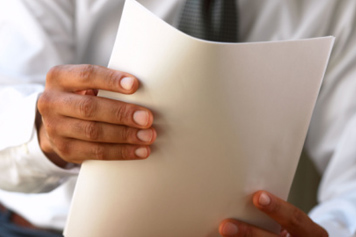 Man Holding Criminal Background Check Paperwork